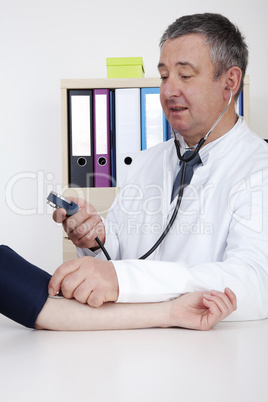 experienced doctor measures blood pressure