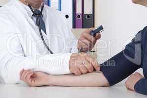 experienced doctor measures blood pressure