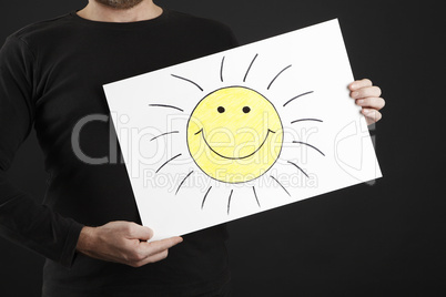 Man holding billboard with sun