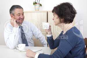 man and woman chat over a cup of coffee