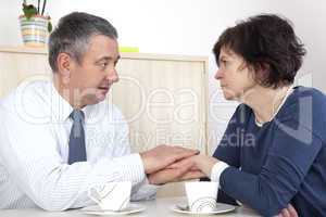 man comforting woman over a cup coffee
