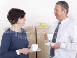 man and woman chat over a cup of coffee