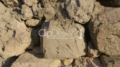 Dolly: Stone wall of ancient ruins at archaeological site