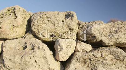 Dolly: Stone wall of ancient ruins at archaeological site