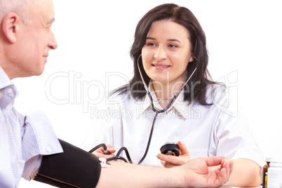 doctor measuring  blood pressure  of senior man
