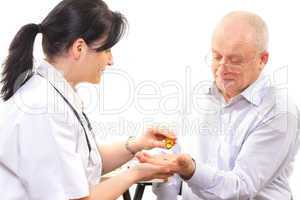 doctor giving the medicine to a senior man