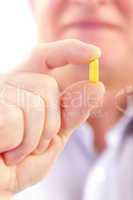senior man taking pill