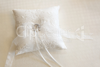 Wedding rings on a white ring pillow