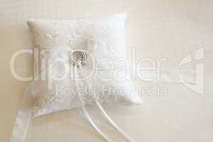 Wedding rings on a white ring pillow