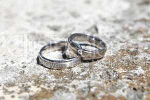 Wedding rings on a stone wall