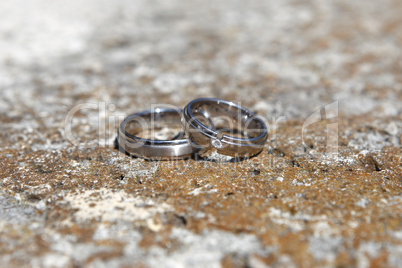 Wedding rings on a stone wall