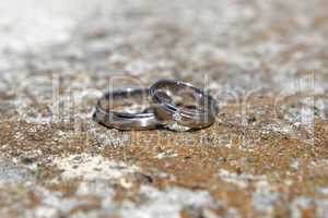 Wedding rings on a stone wall