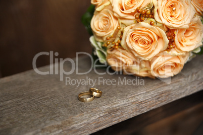 Apricot color bridal bouquet with wedding rings