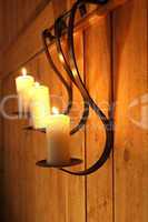 Burning candles as wall decoration