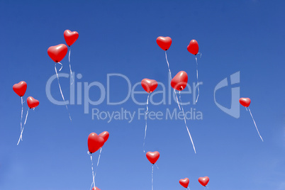 Red balloon hearts in the sky