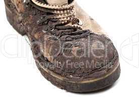 part of old dirty hiking boot on white background