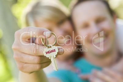 Couple Holding House Key with Home Text
