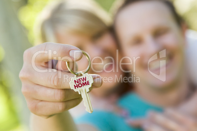 Couple Holding House Key with New Home Text