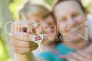 Couple Holding House Key with New Home Text