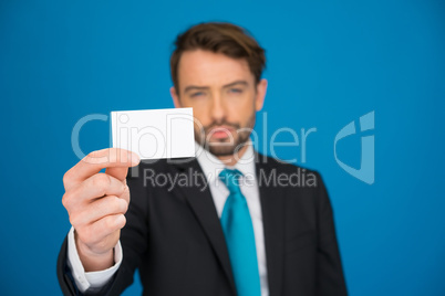 handsome businessman showing blank business card