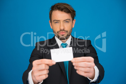 handsome businessman showing blank business card