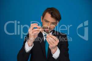 businessman topping up his e-cigarette with e-liquid
