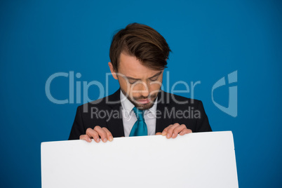 businessman holding blank poster