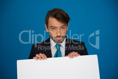 businessman holding blank poster