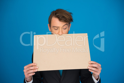 businessman holding blank poster