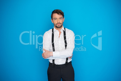 handsome man on blue wearing white shirt and braces