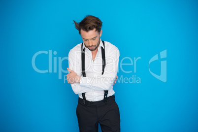 handsome man on blue wearing white shirt and braces