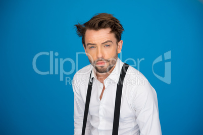 handsome man on blue wearing white shirt and braces