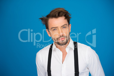 handsome man on blue wearing white shirt and braces