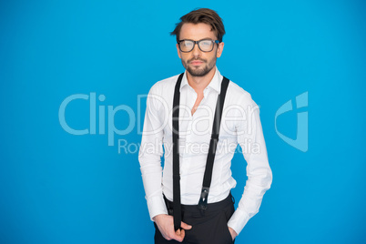 handsome man on blue wearing white shirt and braces