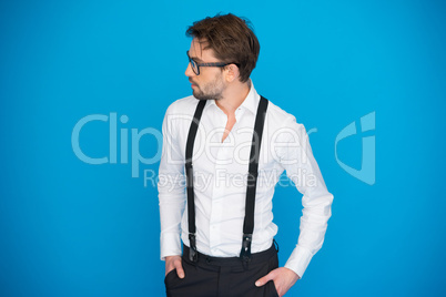 handsome man on blue wearing white shirt and braces