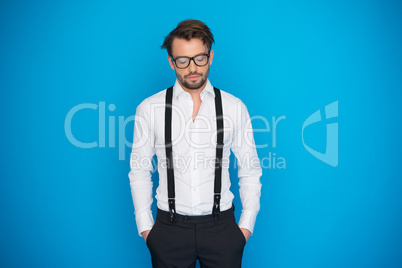 handsome man on blue wearing white shirt and braces