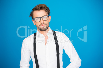 handsome man on blue wearing white shirt and braces