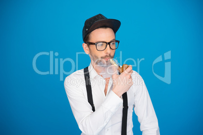 man wearing shirt and hat smoking e-pipe