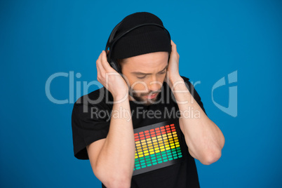 man wearing headphones on blue