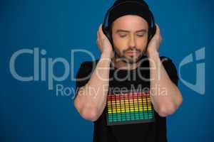 handsome male dj with headphones on blue