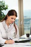 businesswoman writing in office