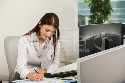 businesswoman writing at desk