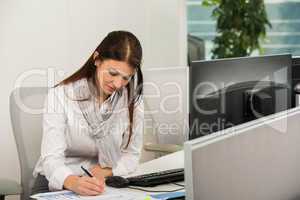 businesswoman writing at desk