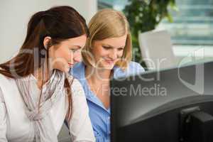 businesswomen looking at computer monitor