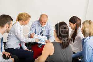 business team discuss graph sitting meeting room