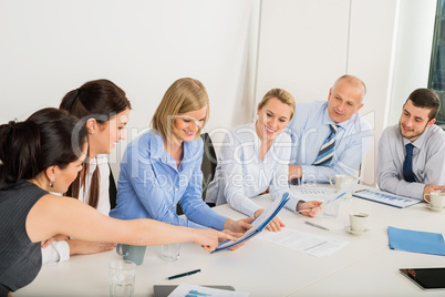 business team sitting around meeting table