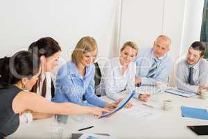 business team sitting around meeting table