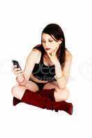 girl sitting with cell phone.