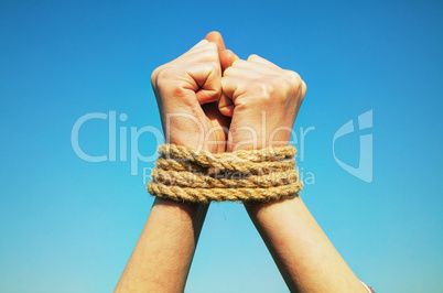 Hands tied up with rope