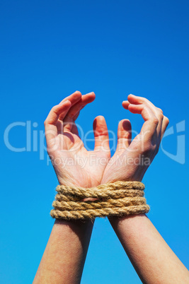 Hands tied up with rope